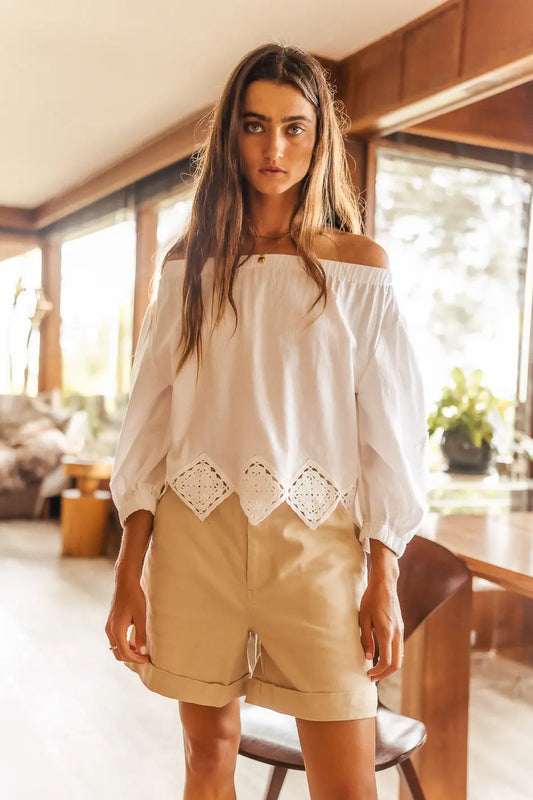 Short in tan paired with a off shoulder woven top 