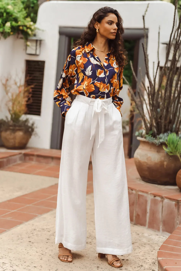 floral blouse with white wide leg pants and sandals