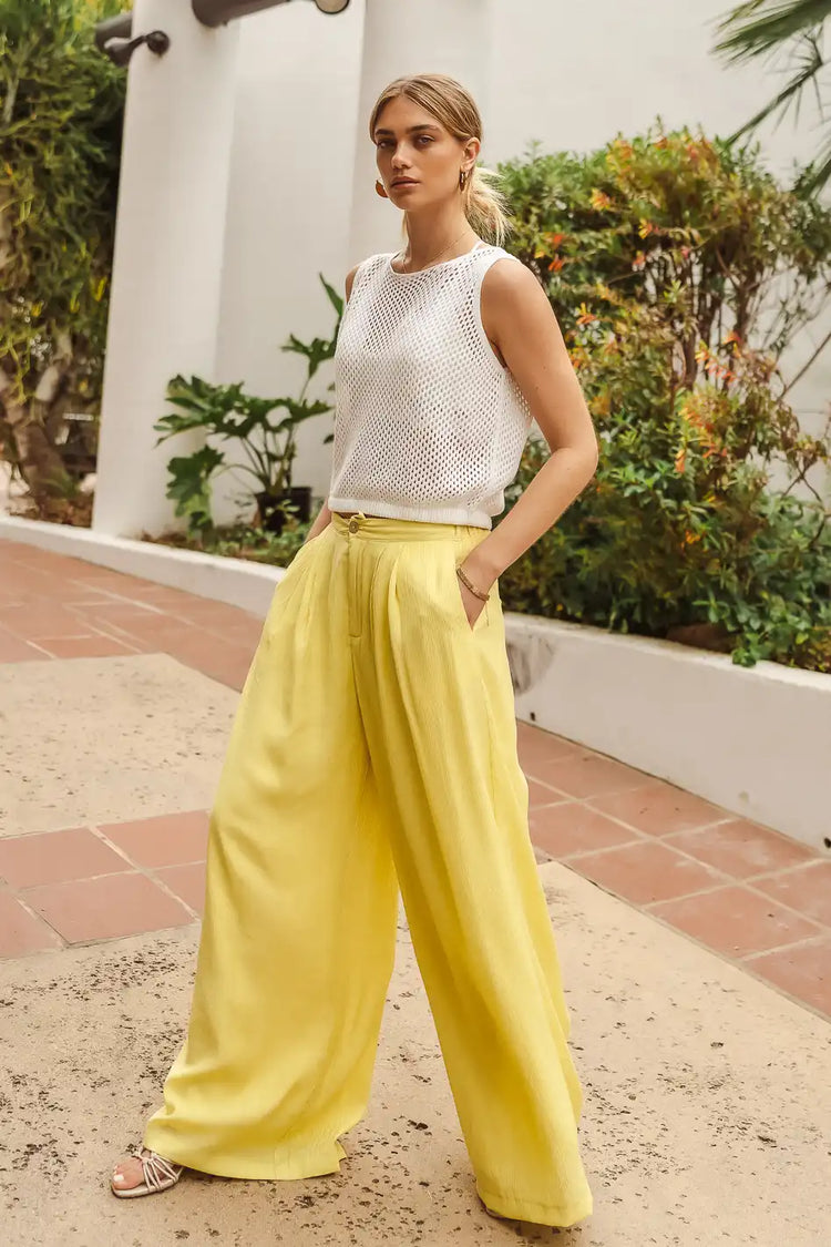 Wide legs in yellow paired with a white top 