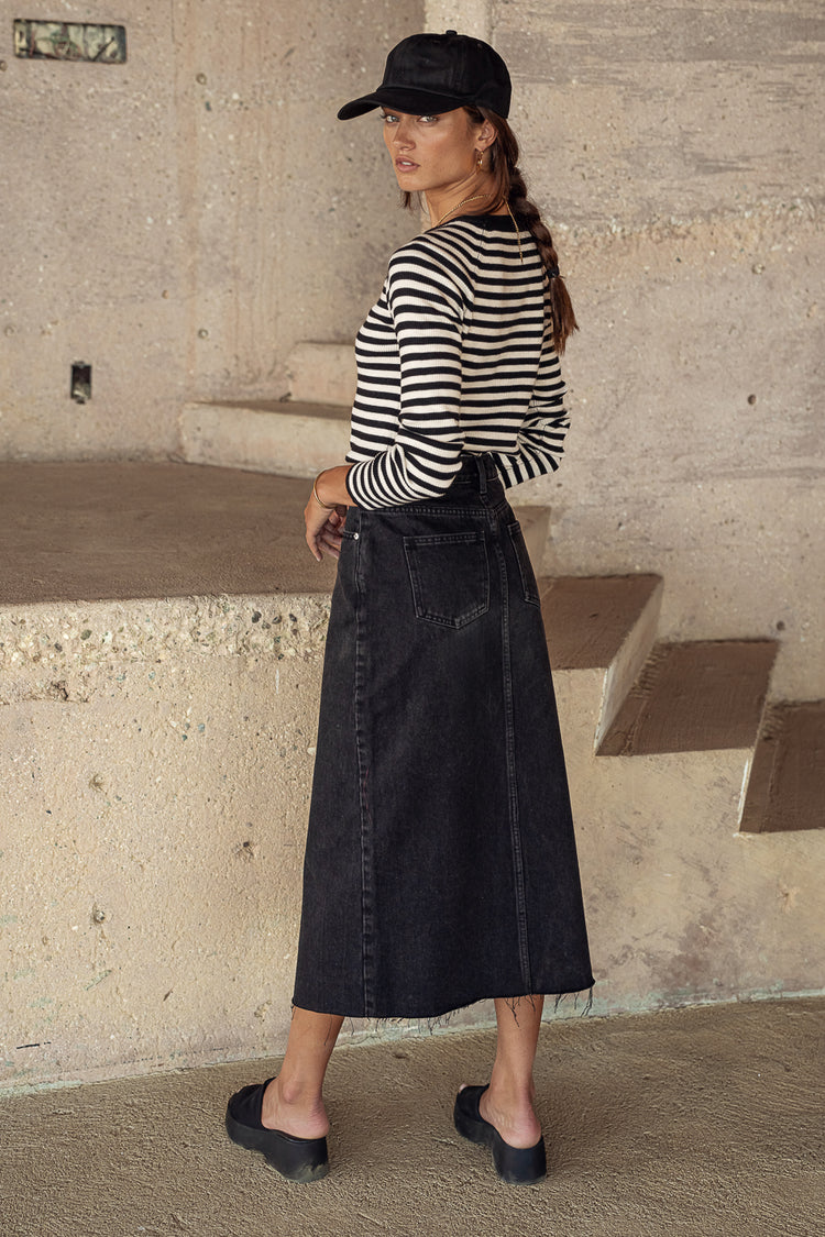 Black denim skirt paired with a striped long sleeve top