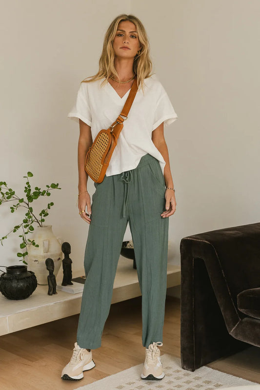 Pants in teal paired with a white top 