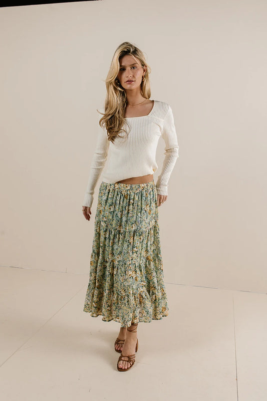Top in ivory paired with a floral skirt 