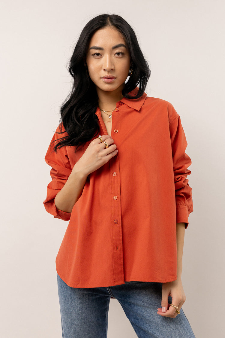 model wearing red long sleeve button down 