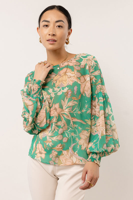 green blouse with floral print