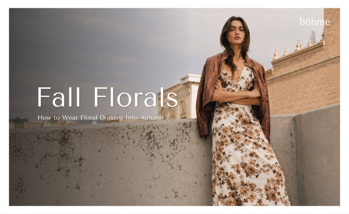 Woman wearing a floral maxi dress with a brown leather jacket.