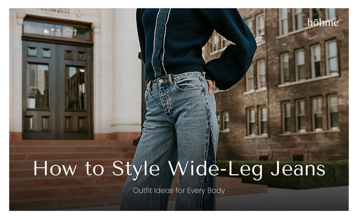 Close-up of wide-leg denim jeans styled with a navy sweater
