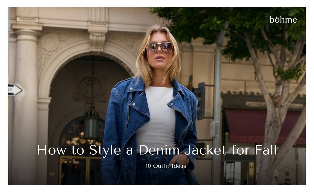 Woman wearing a blue denim moto jacket over a white top with oversized sunglasses.