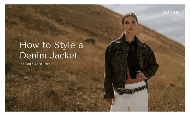 Woman wearing a dark denim jacket with a black top, white pants, and a studded belt