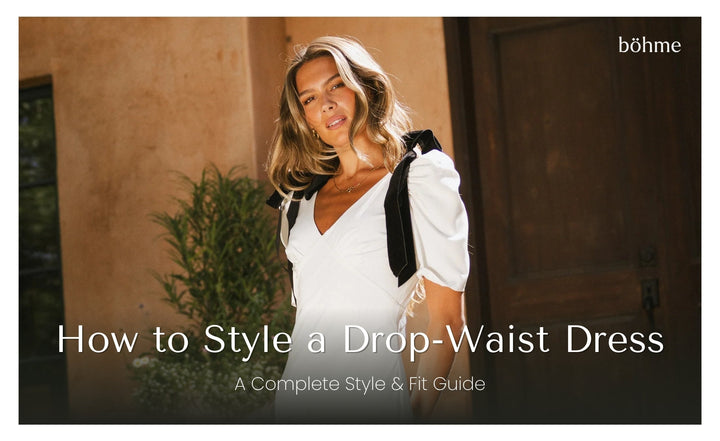 Woman in white v-neck drop-waist midi dress with puff sleeves and black velvet shoulder bow