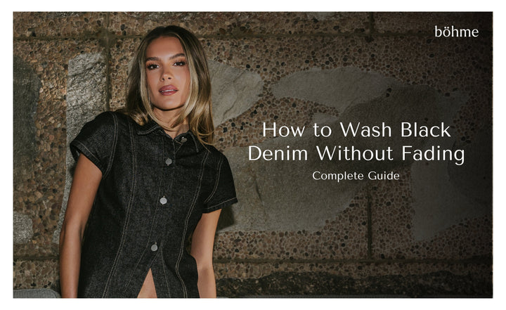 Woman in black button-front denim shirt against a stone wall
