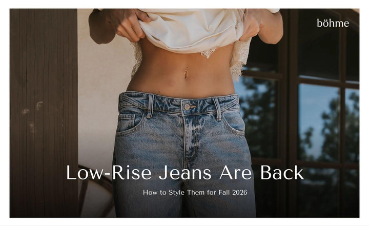 Woman wearing low-rise blue jeans with a white cropped lace-trim top.
