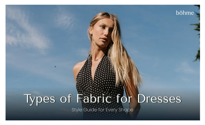 Woman in a black and white polka dot halter dress against a blue sky