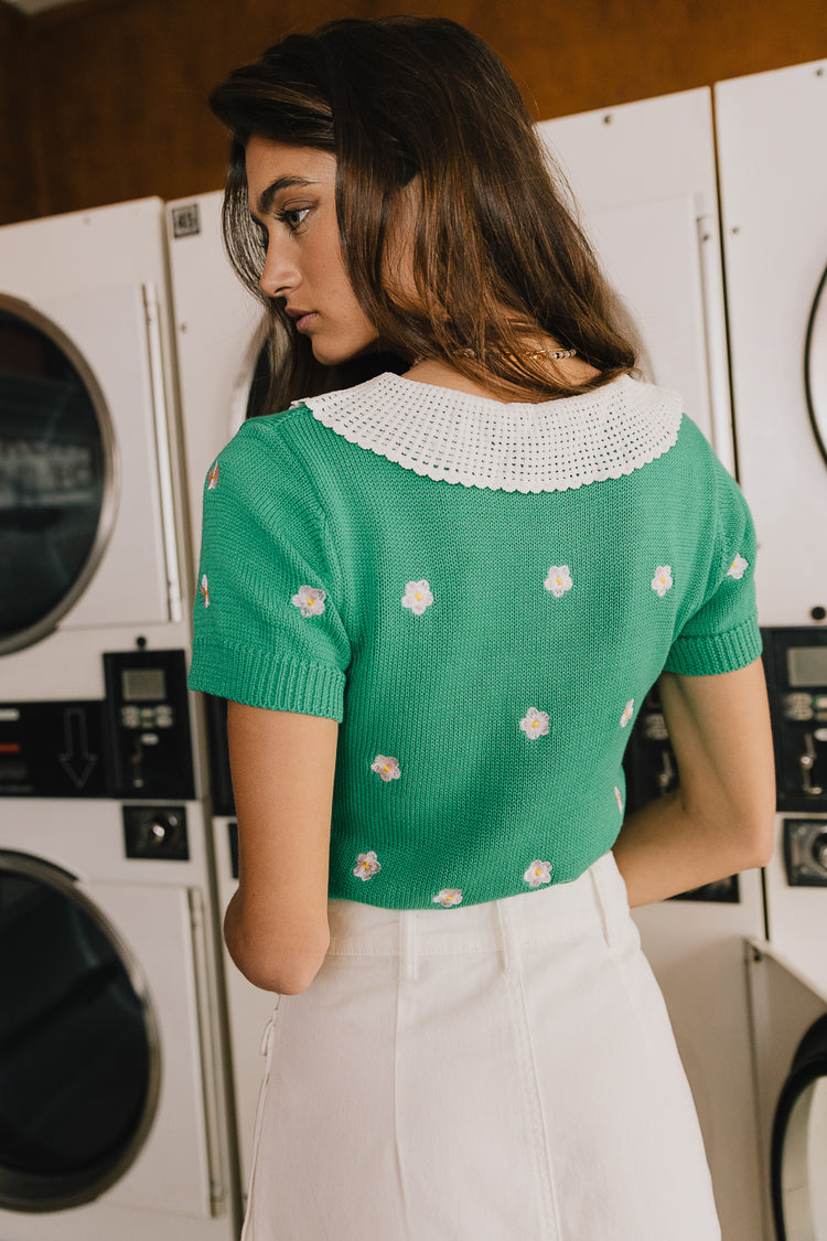 green top with floral detail