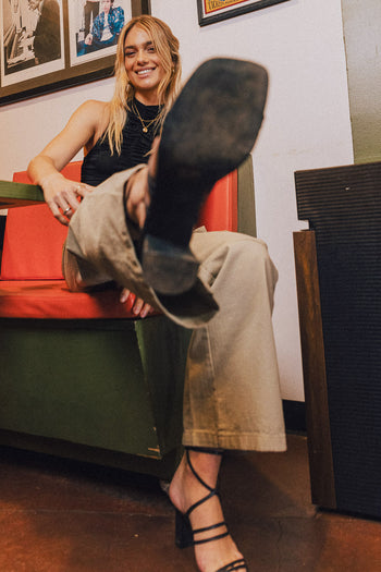 model wearing black lace up heels