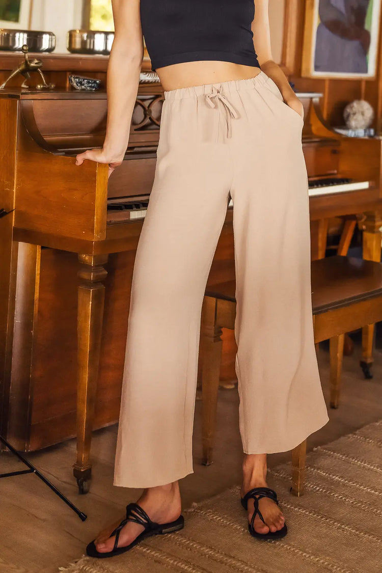 wide leg pants in tan with black sandal and top
