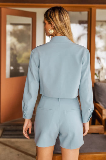 Shorts in blue paired with a crop blazer 