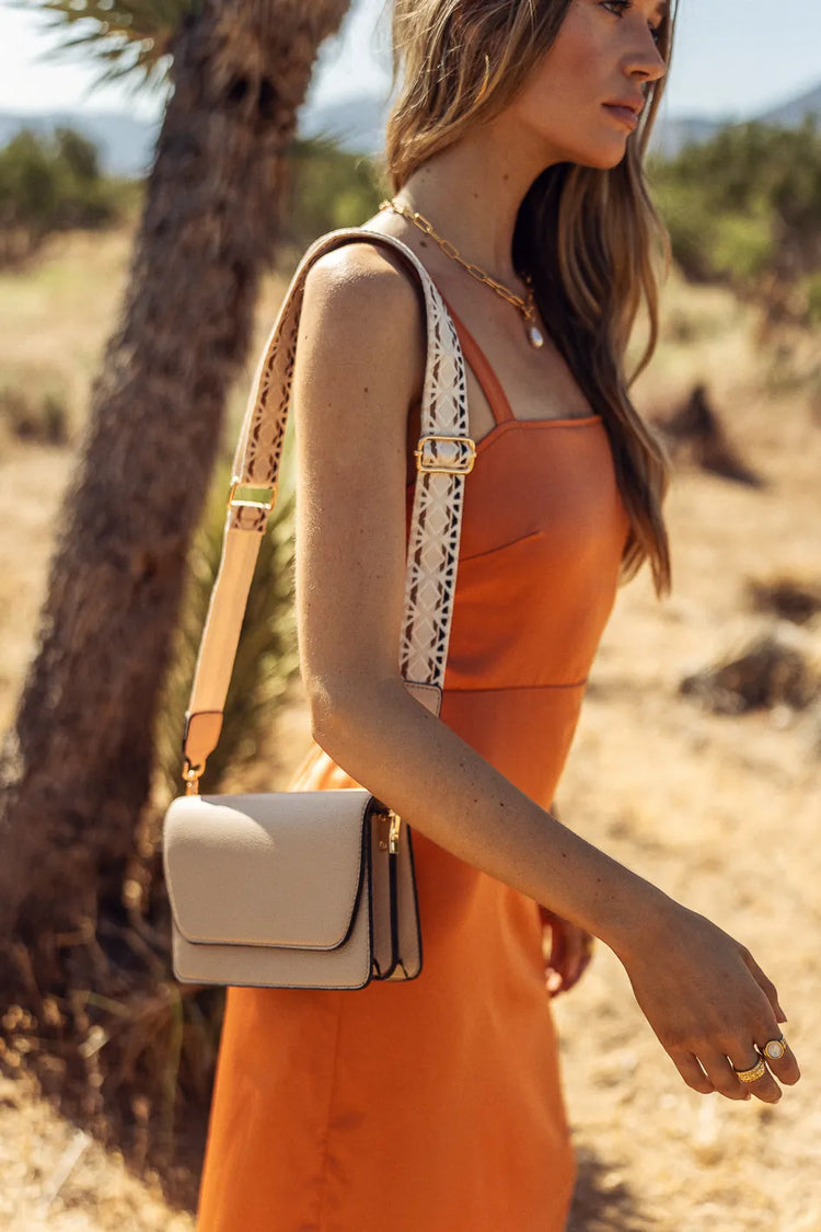 beige crossbody with printed strap 