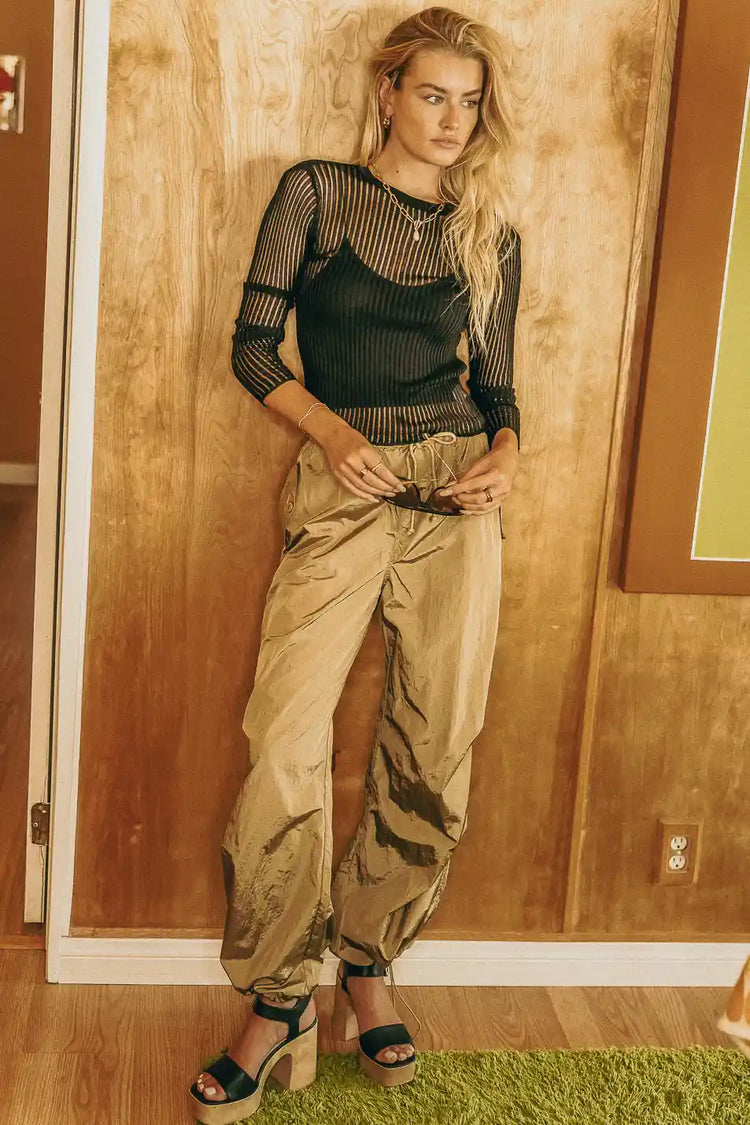 Parachute pants in tan paired with a black long sleeves top
