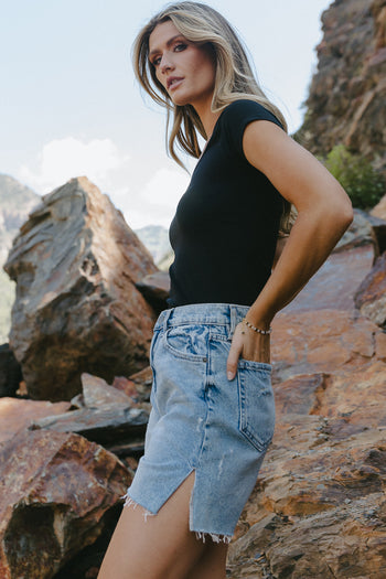 Knit basic top in black paired with a denim shorts 