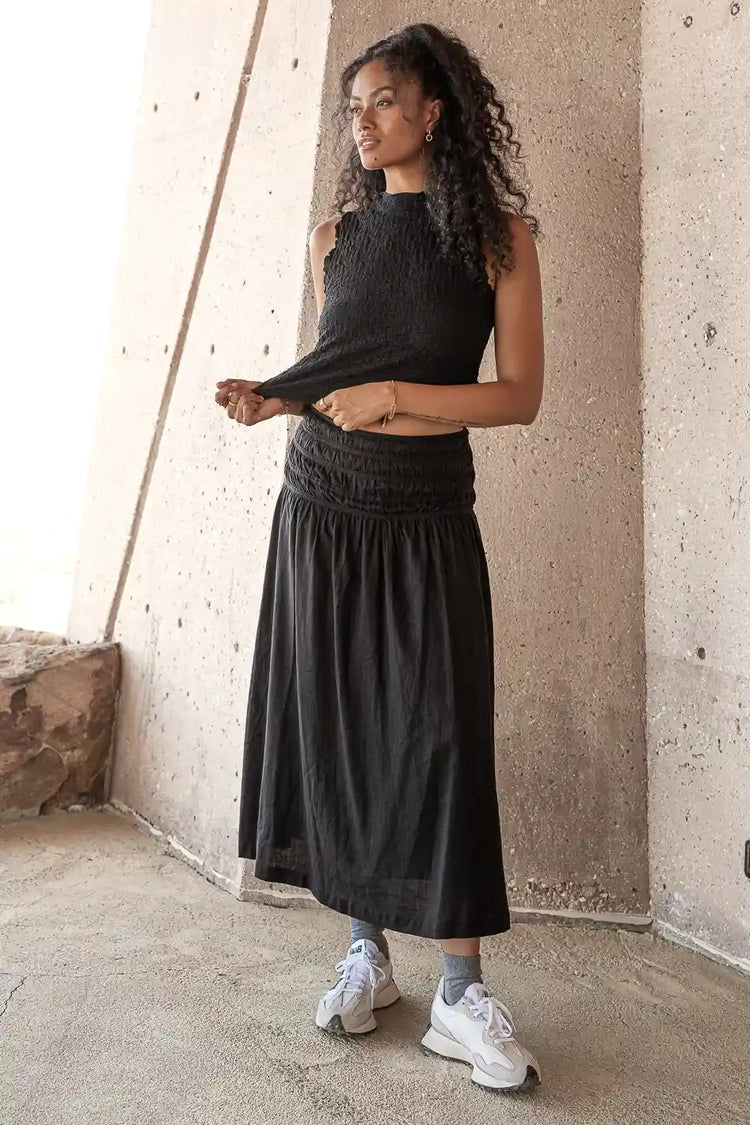 Black textured top paired with a long skirt 