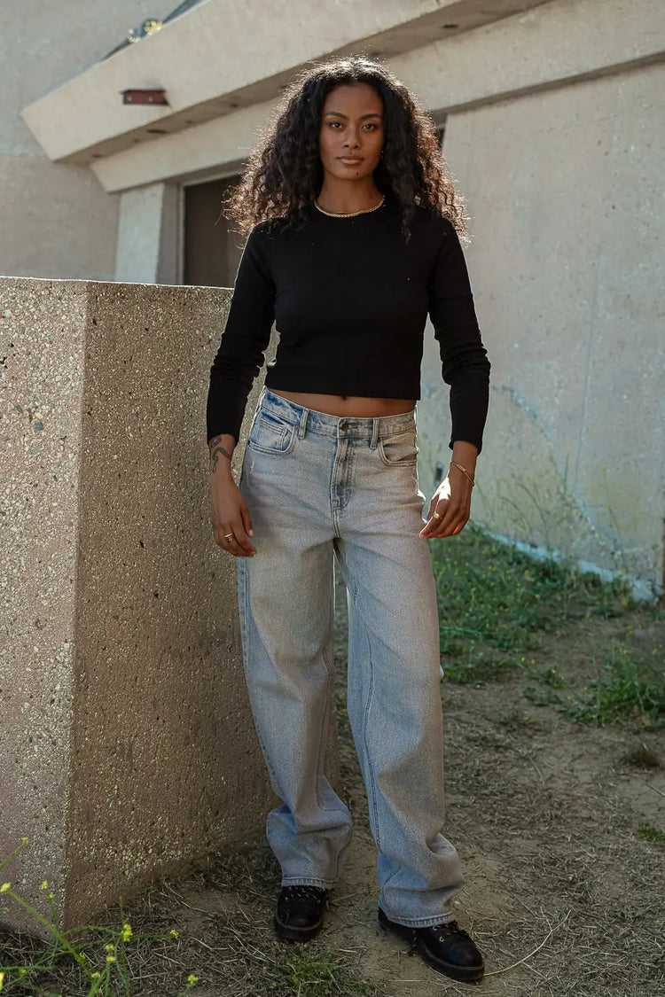Black Cropped top paired with denim pants  