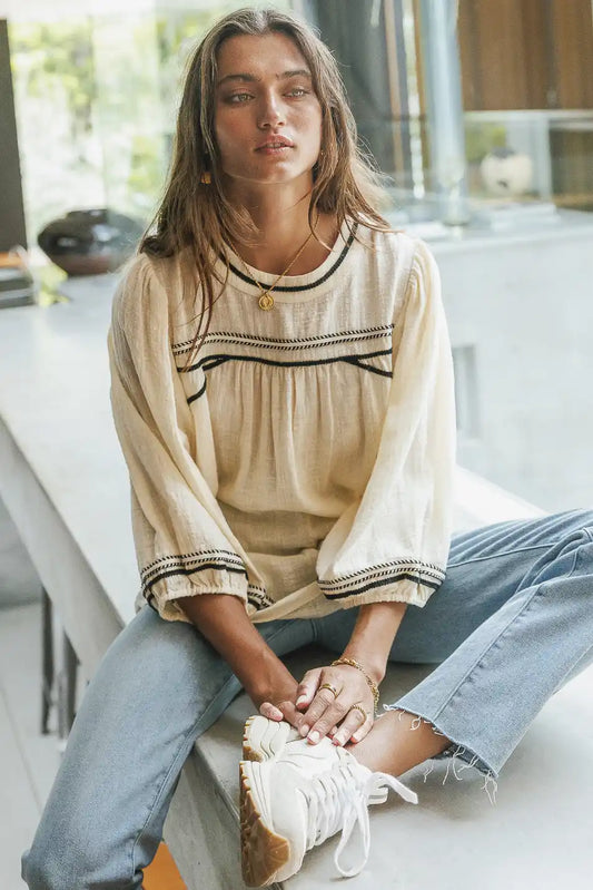 Top in cream paired with a light wash Denim 