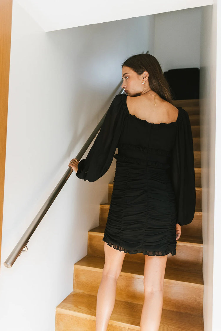 back side of long sleeve mini dress in black 
