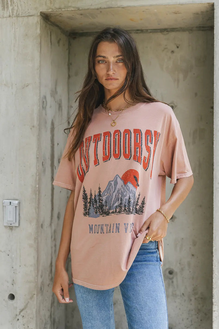 mauve tee with outdoorsy graphic with mountains