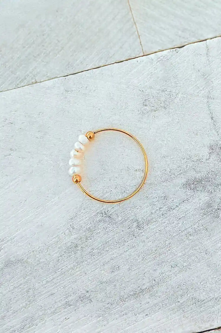 tiny gold ring with tiny white pearls  