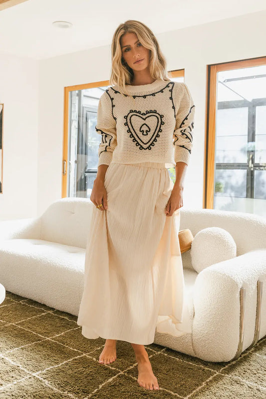 Knit sweater paired with a maxi skirt in cream 