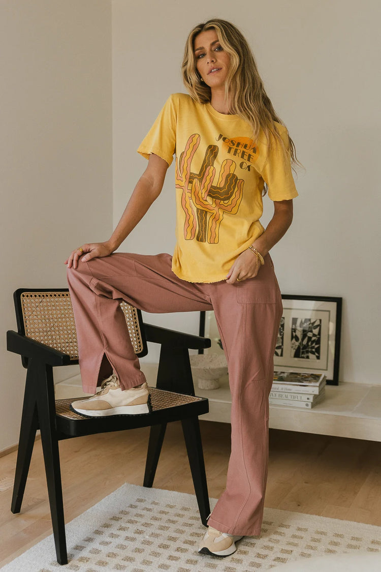 Straight leg pants in lavender paired with a mustard graphic tee 