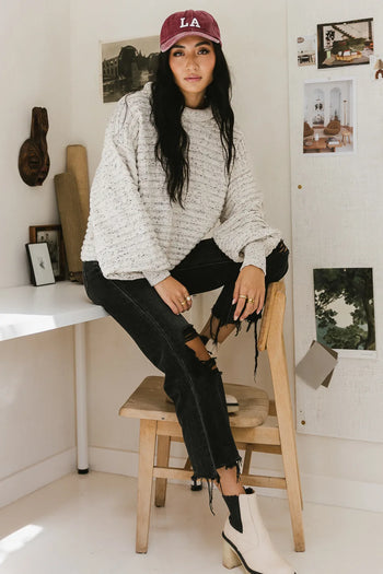 Ribbed sweater paired with a distressed denim 