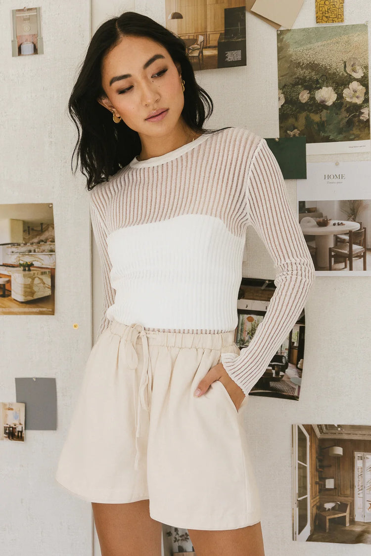 Ribbed knit top in white paired with cream shorts 