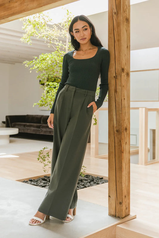 Wide leg pant in teal paired with a ribbed sweater in hunter green 