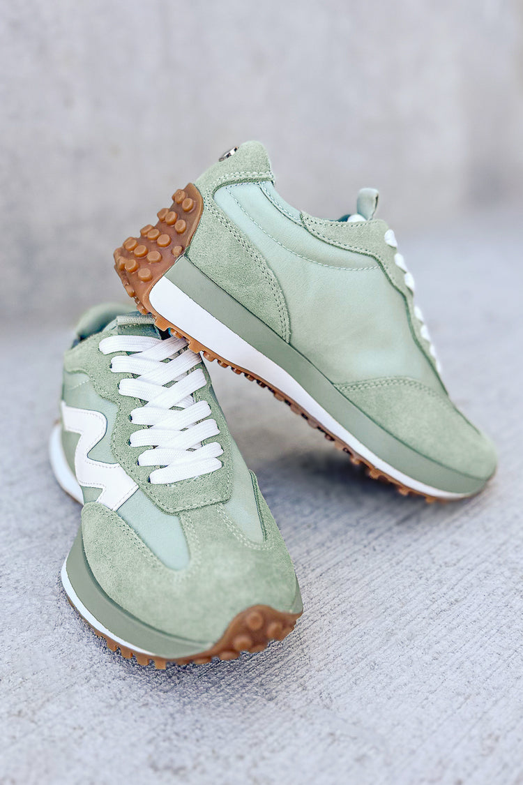 green sneakers with white detail