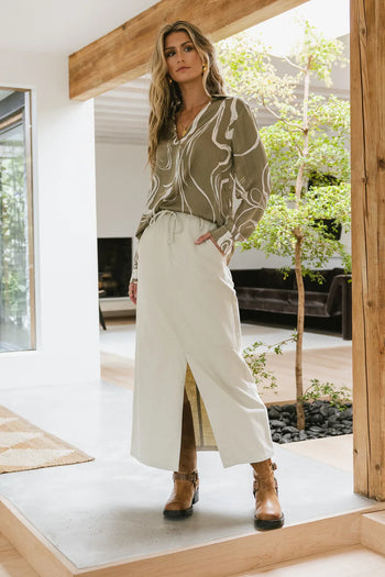 Maxi skirt paired with a printed green blouse 