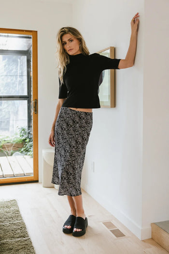 Knit mock neck paired with a midi skirt 