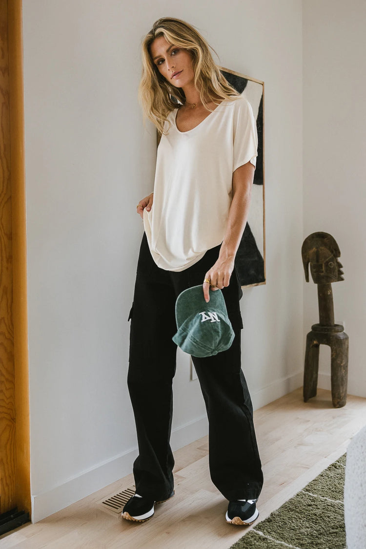 Oversized top in ivory paired with a black cargo pants 
