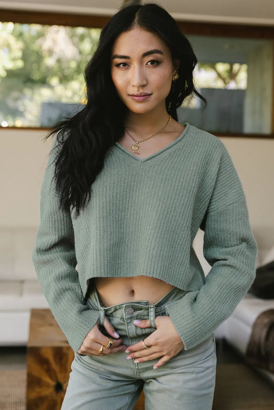 V-Neck sweater in sage paired with a distressed denim 
