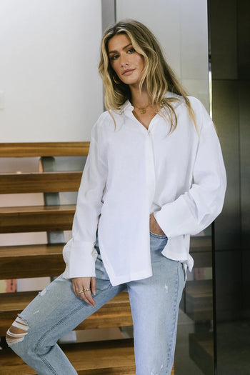 Button up in white paired with a distressed denim 