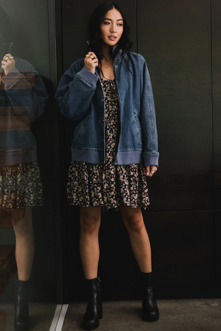 Flower mini dress paired with a denim jacket 