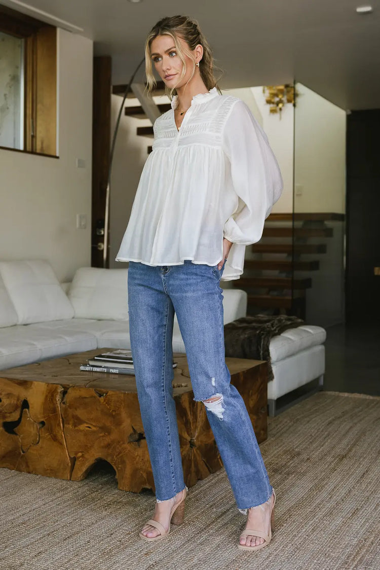 Blouse in cream paired with a medium wash denim jean 