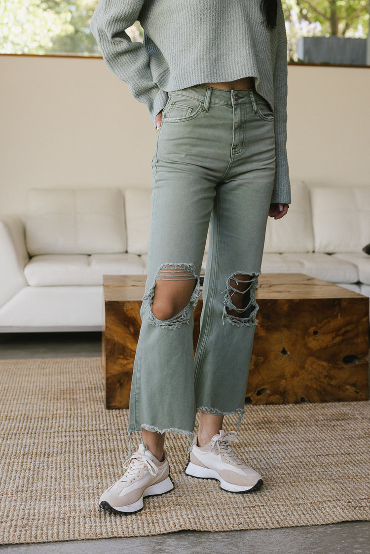 green denim jeans with distressed knee 