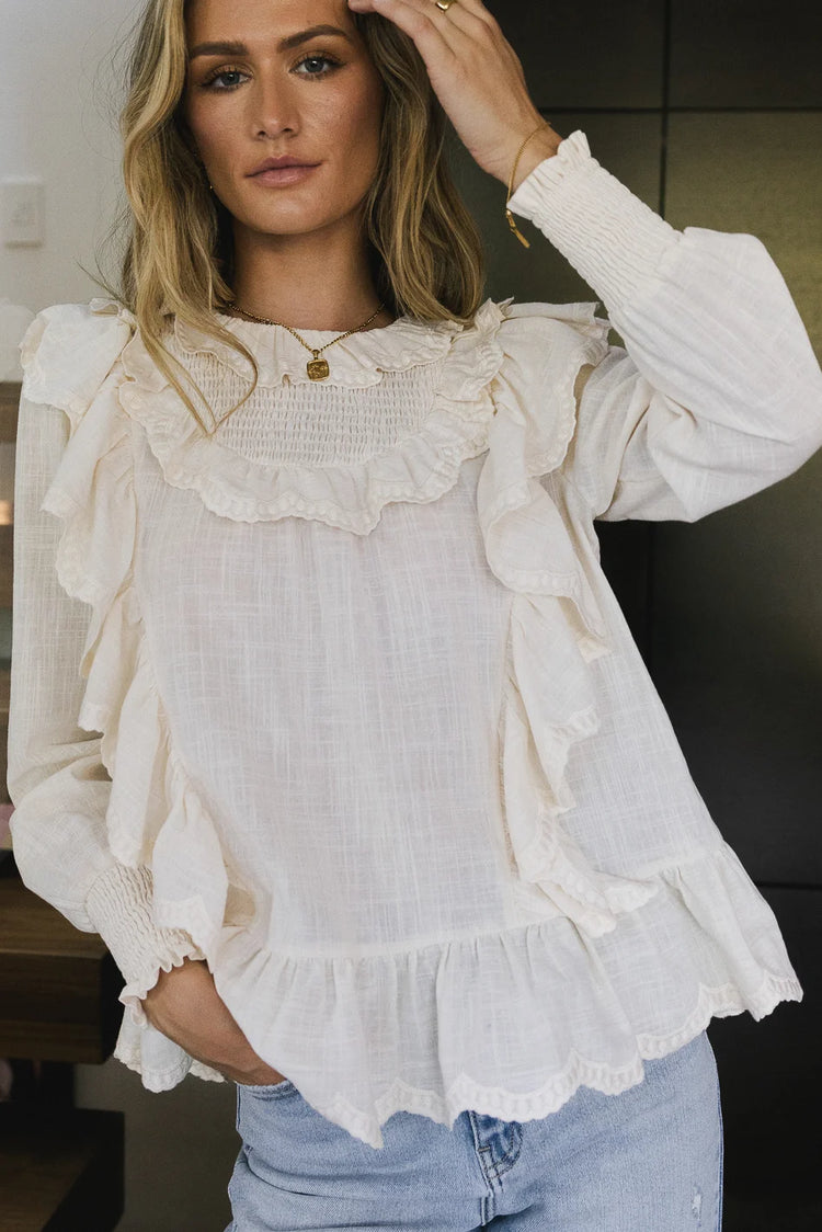 Round ruffle neck blouse in ivory 