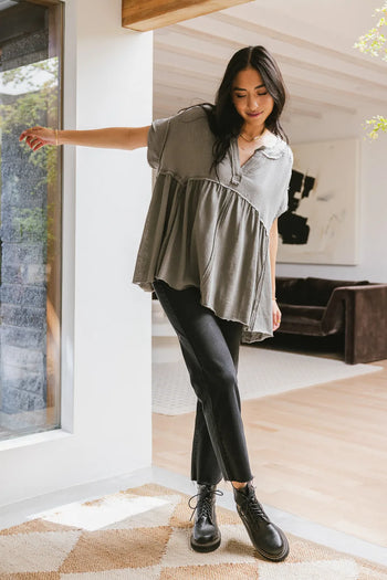 Top in sage paired with a black denim 