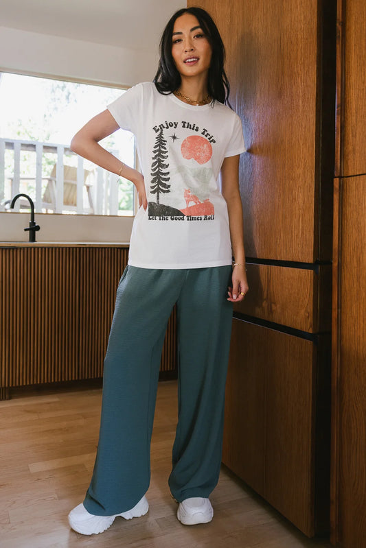 Wide leg pants in teal paired with a graphic tee
