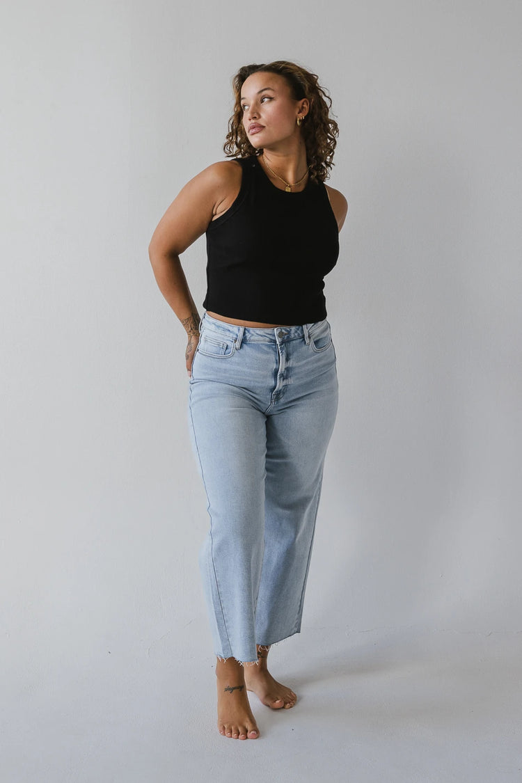 High rise wide leg jeans paired with a black tank top 
