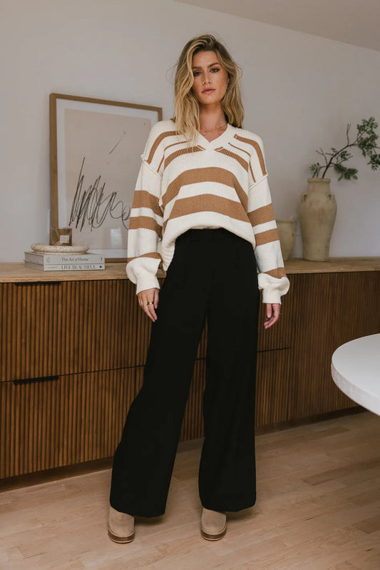 Sweater paired with a wide leg black pants 