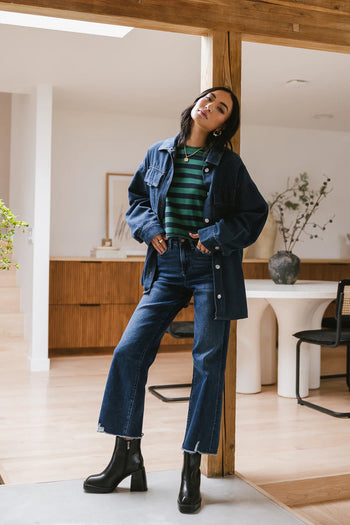 Striped top in green paired with a dark denim button up 