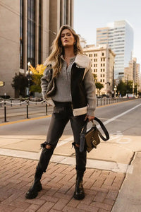 grey sweater with black coat, jeans and boots